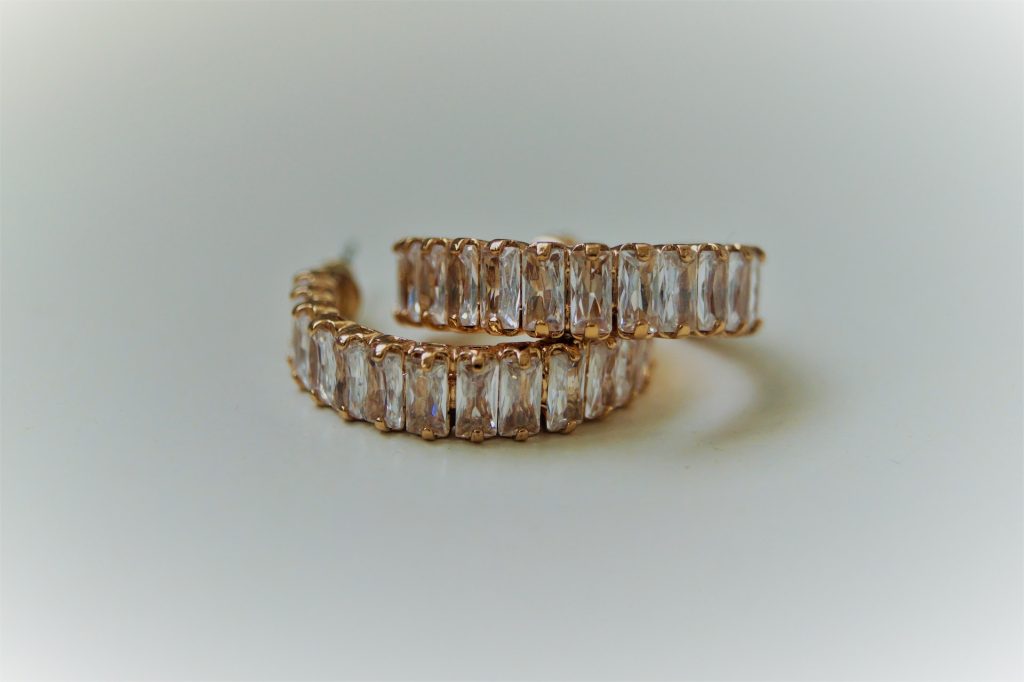 bronze earrings on white background