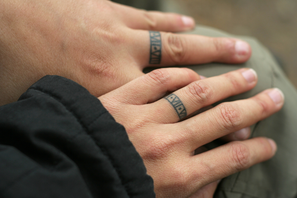 a couple with ring tattoos on their ring fingers