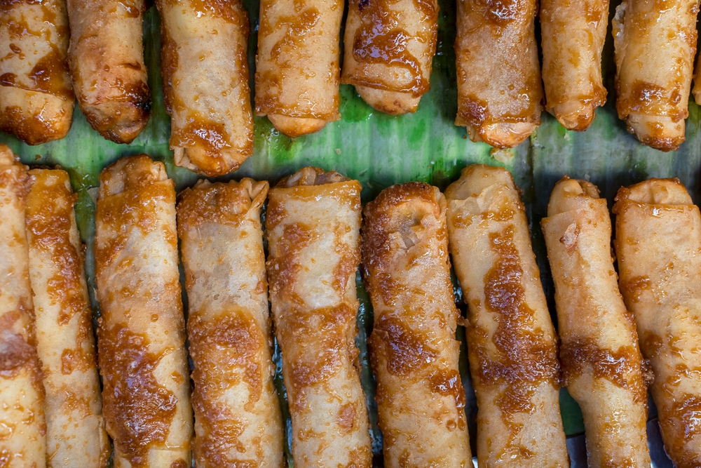 Banana Turon, a deep fried and sweet street food, lined on banana leaf