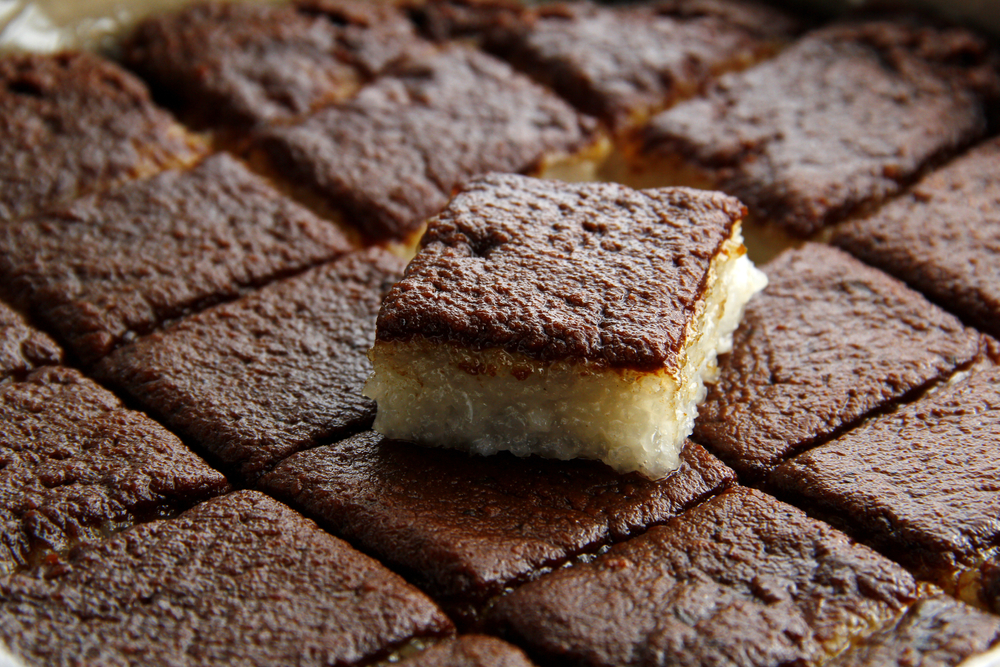 close up picture of Filipino food kakanin or rice cake with a slice on top