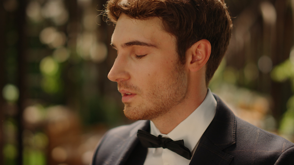 close up portrait of a groom taking a deep breath before wedding ceremony