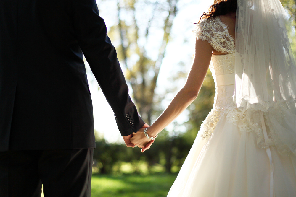 close up shot of newlyweds holding hands