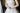 neck cropped of young nervous bride in a white wedding dress holding her hands