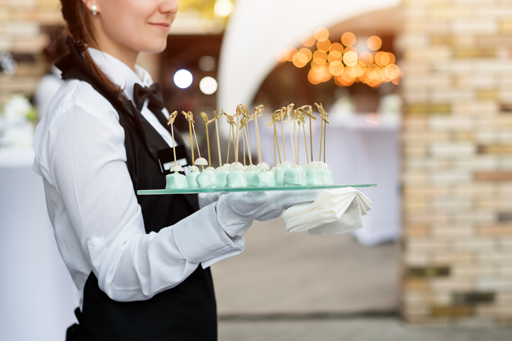waitress holding a tray of finger food on wedding event