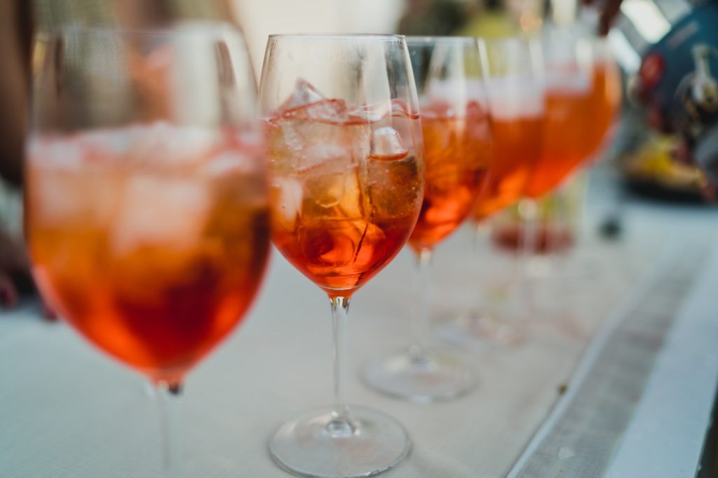 Aperol Spritz lined up on top of table