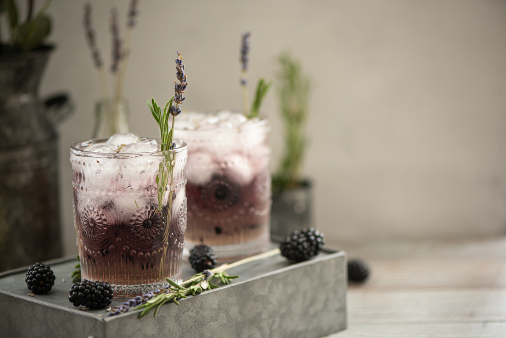 Blackberry Lavender Champagne Cocktail on a light background
