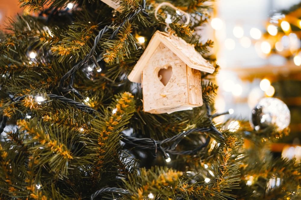 custom house with heart ornament hanging on Christmas tree 