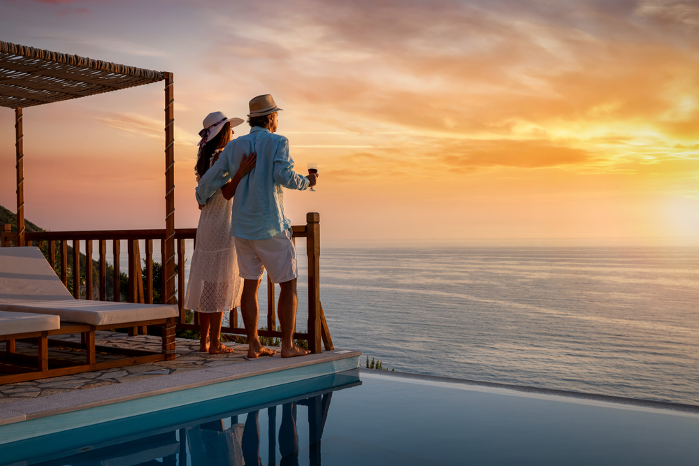 A romantic couple watching sunset over the sea on their second honeymoon