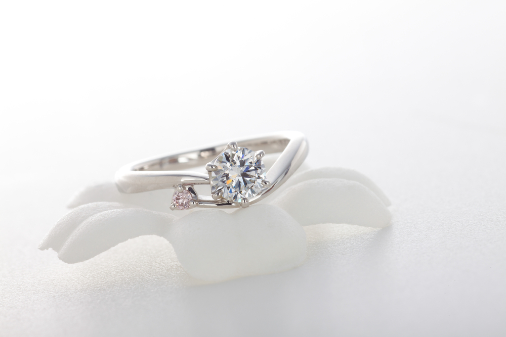 diamond tension setting engagement ring on white background