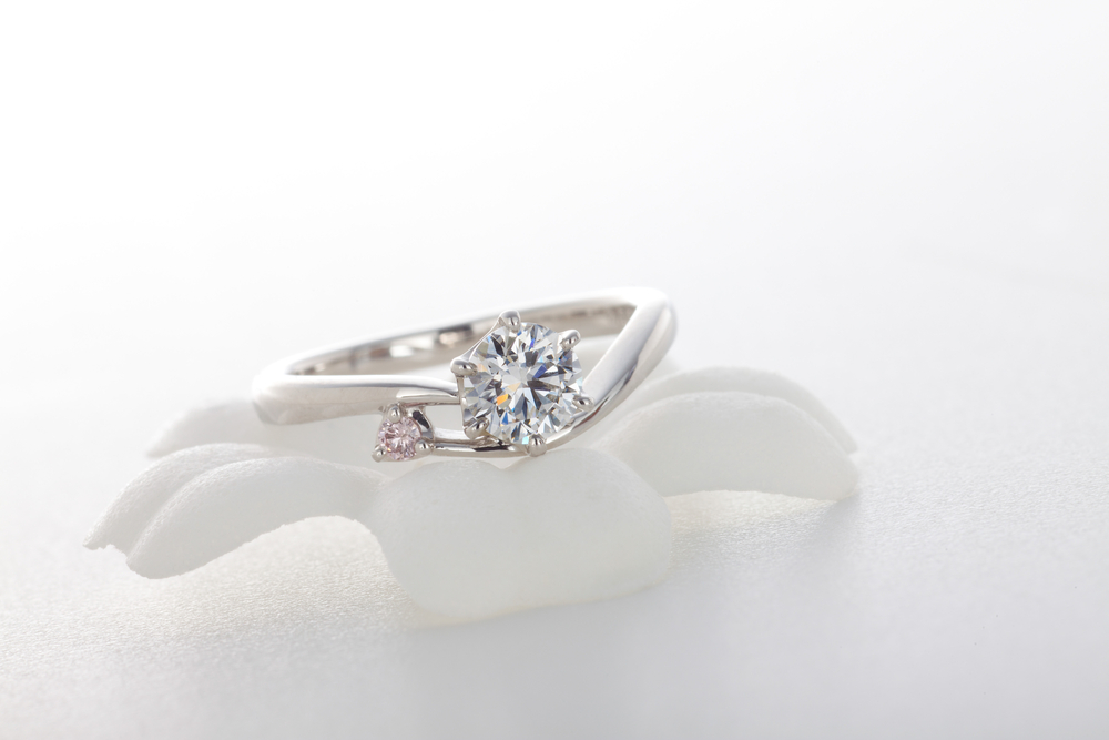 diamond tension setting engagement ring on white background