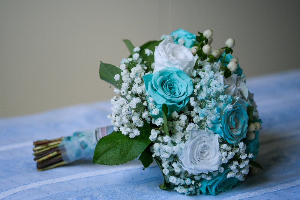 a wedding bouquet of white and light blue tiffany roses