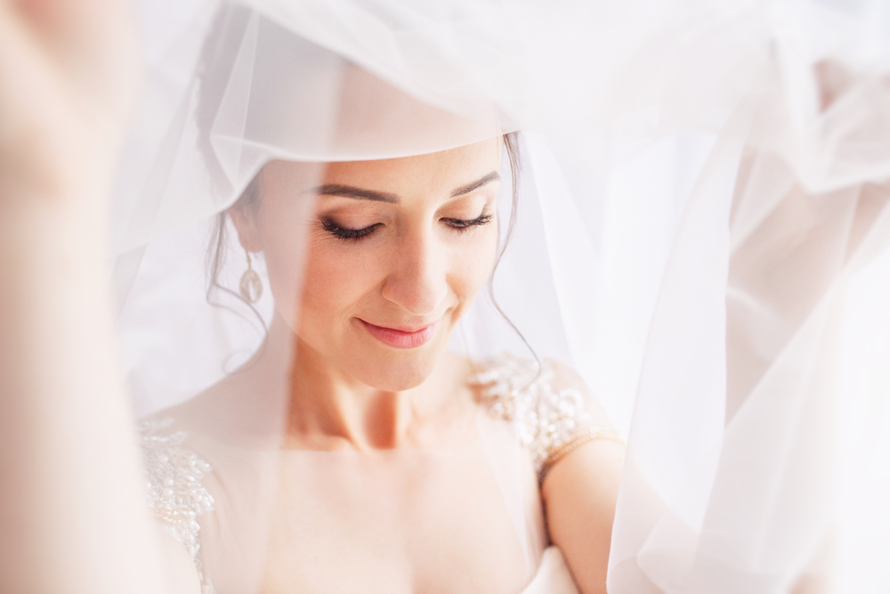 bride under a white wedding veil