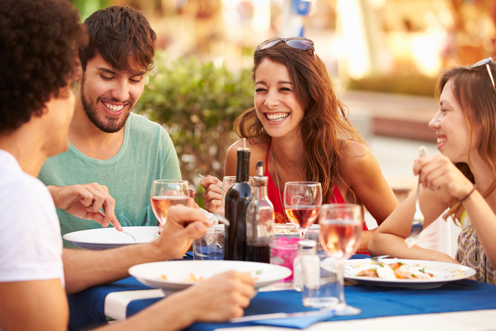 couple having outdoor lunch with their friends