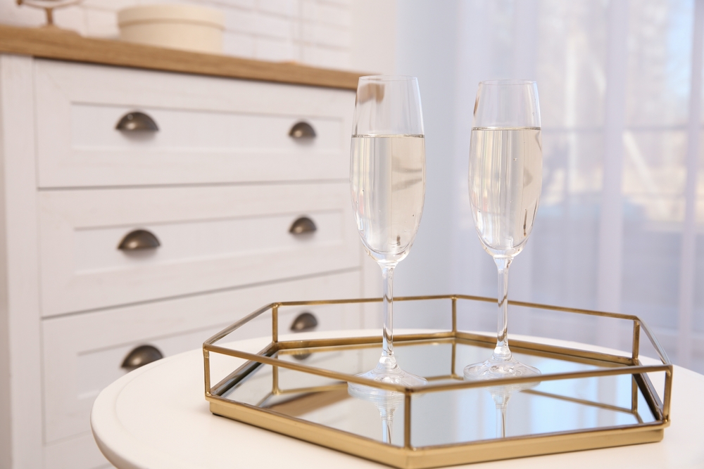 gold and white wine tray with two glasses of white wine