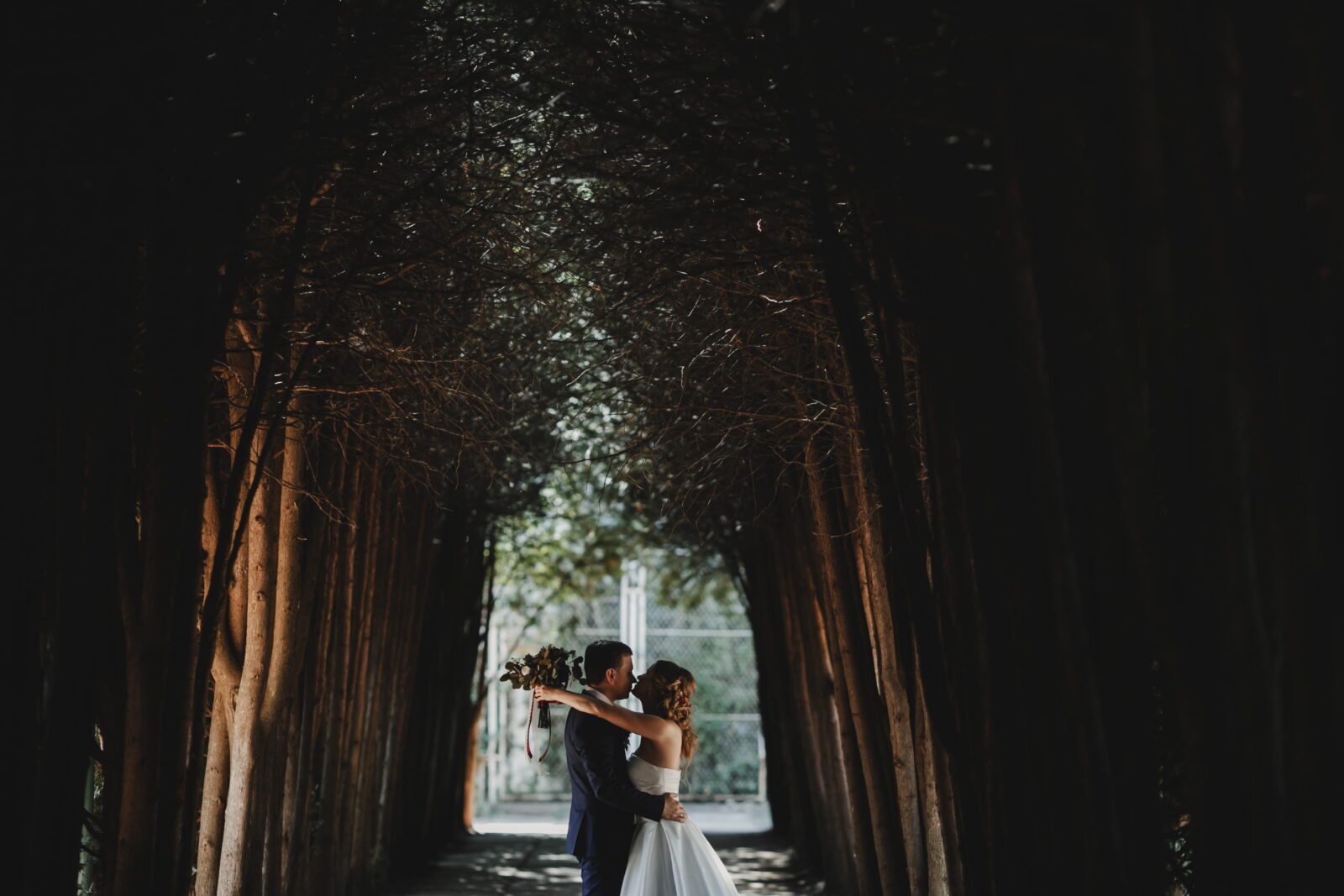 Couple in a dramatic shot between trees