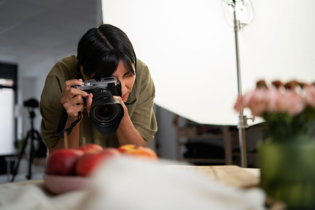 Photographer taking photos of fruits and flowers