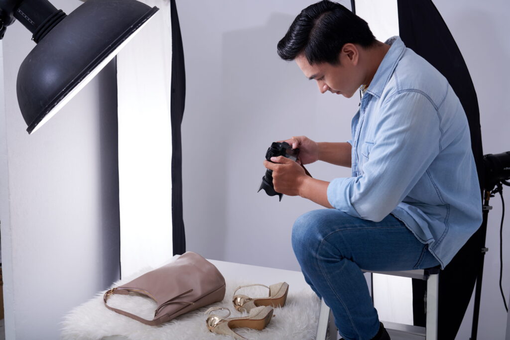 Photographer taking photos of shoes and a bag