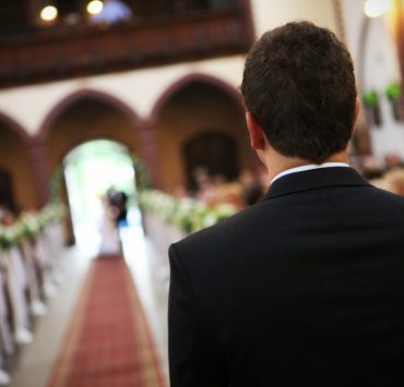 back shot of a young groom waiting for the bride