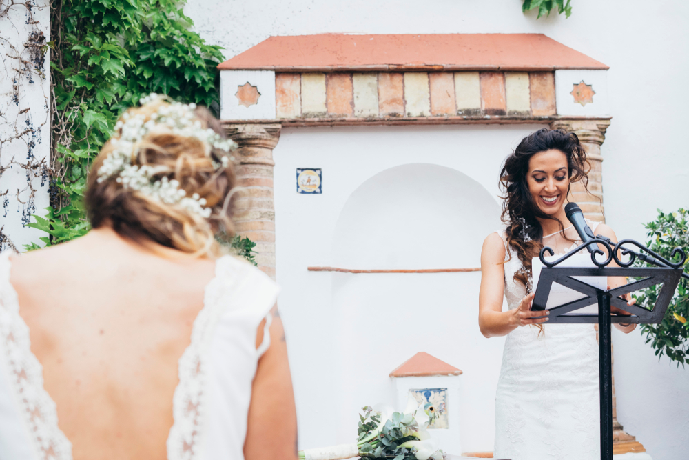 maid of honor giving a speech while the bride is in front