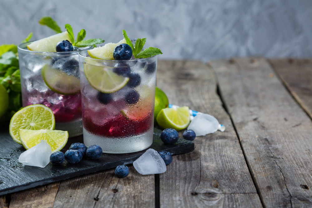 Blueberry mint mojito on rustic wood background