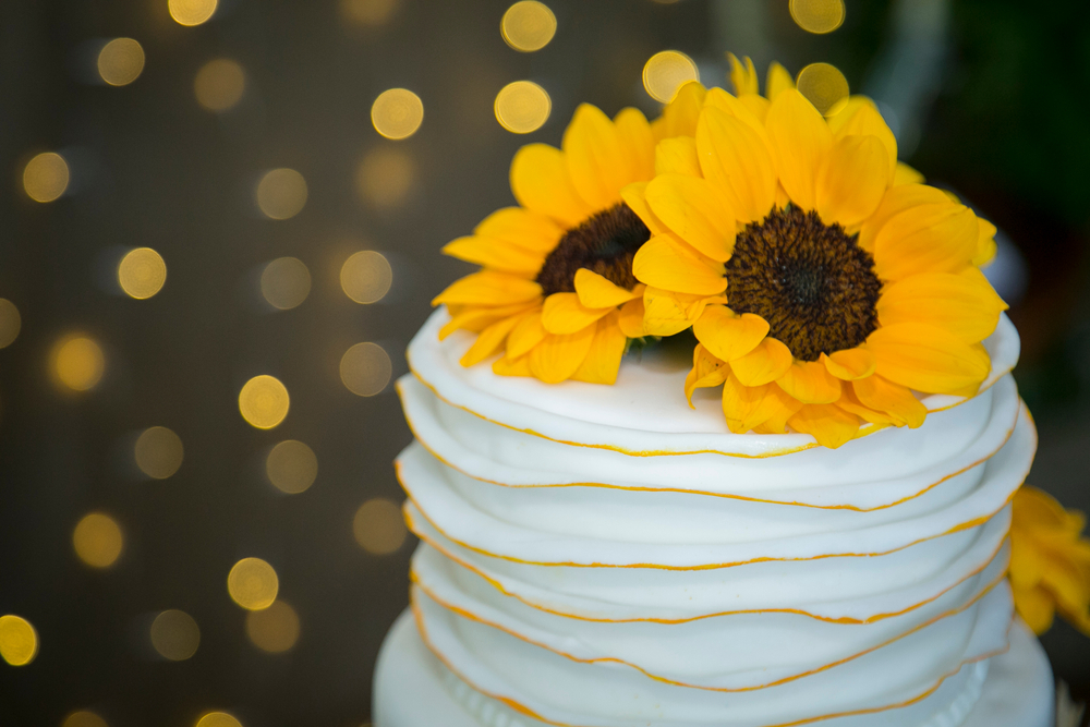 Sunflower Wedding Cake with Bokeh lights in background