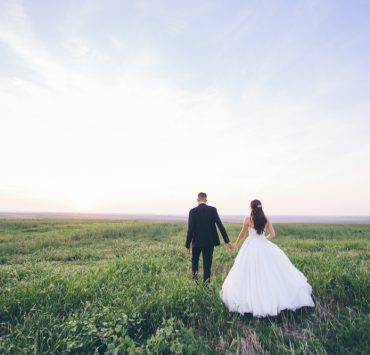 bride and groom walking away after wedding ceremony