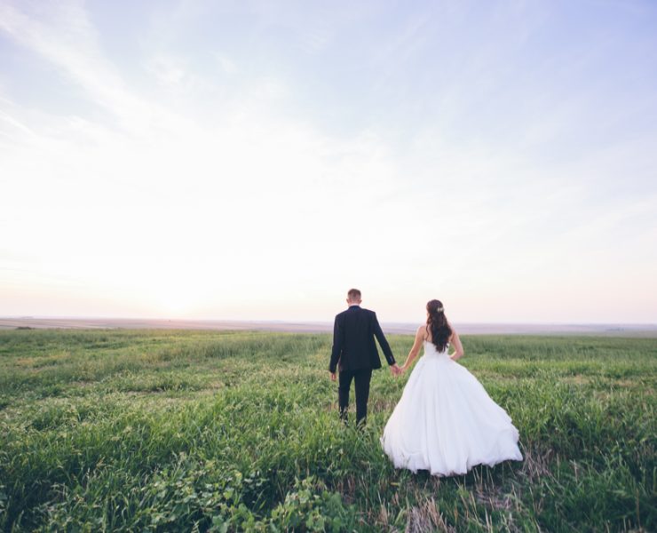 bride and groom walking away after wedding ceremony