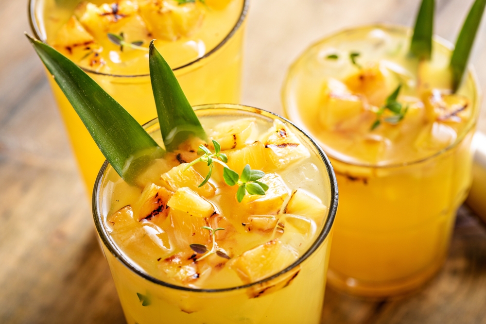 close up of three glasses pineapple sunrise mocktail