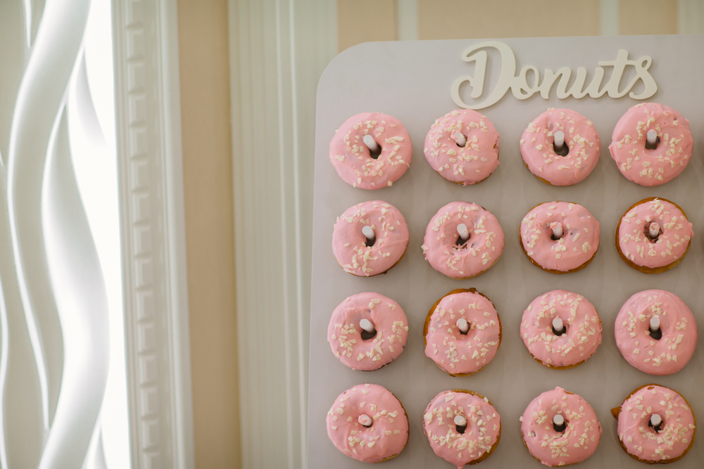 pink donuts on wall at a wedding 