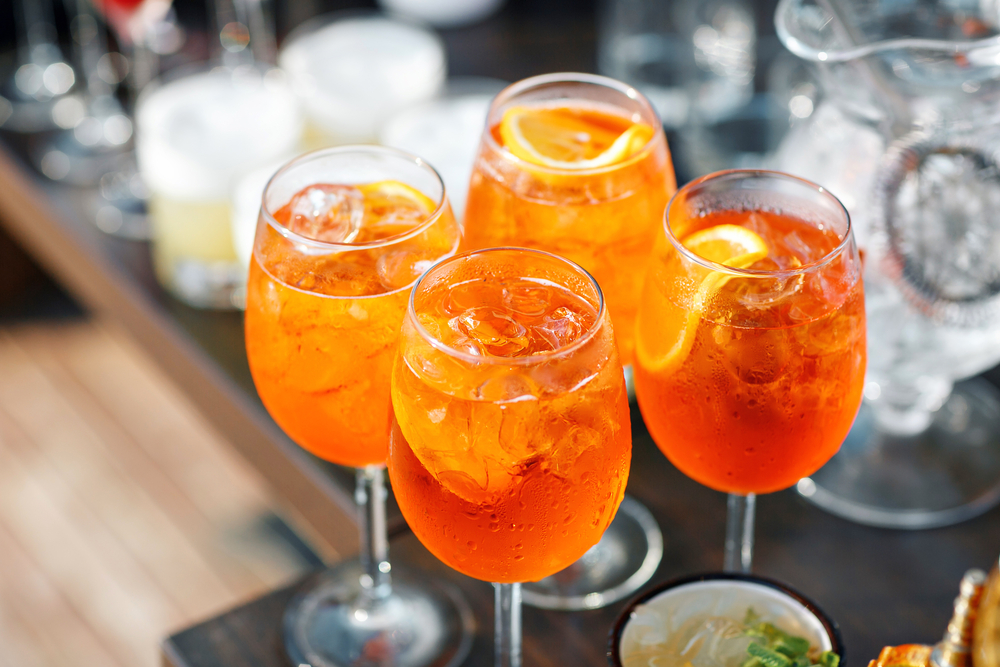 top view of four glasses of Non-Alcoholic Aperol Spritz