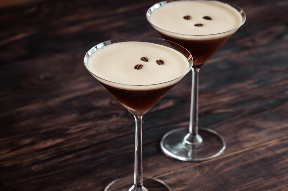 two espresso martini mocktails with coffee beans at top