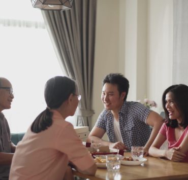 groom talking to his future bride's parents during meal