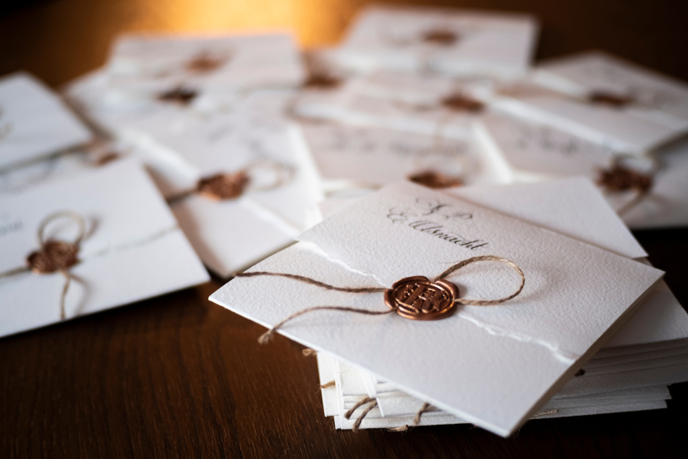pile of vintage wax sealed wedding invitation