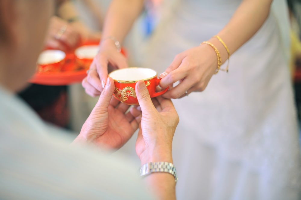 bride and groom serving tea to their parents