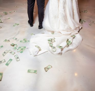 money bills on the floor while bride and groom's first dance