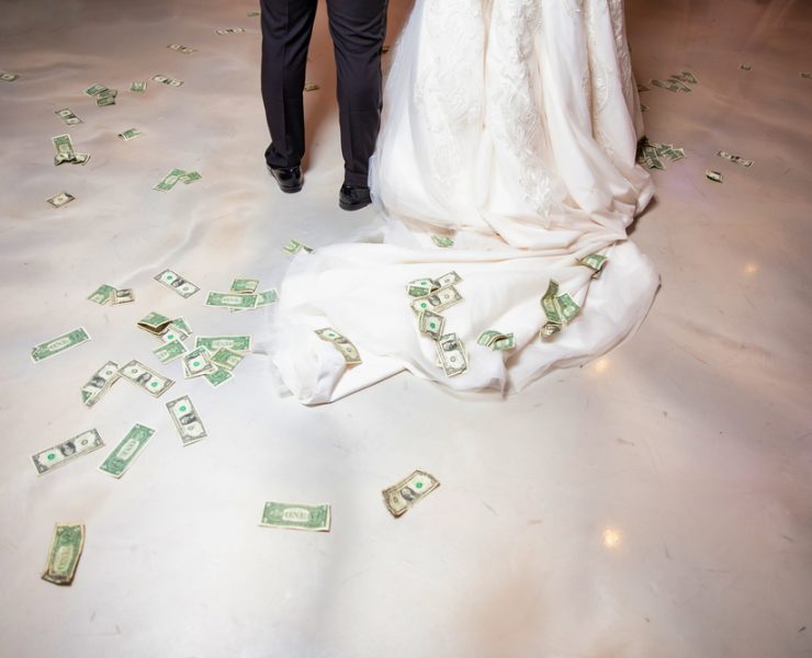 money bills on the floor while bride and groom's first dance