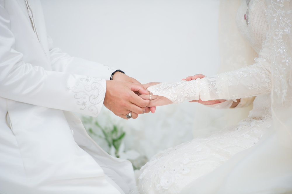 muslim bride and groom wearing white attire
