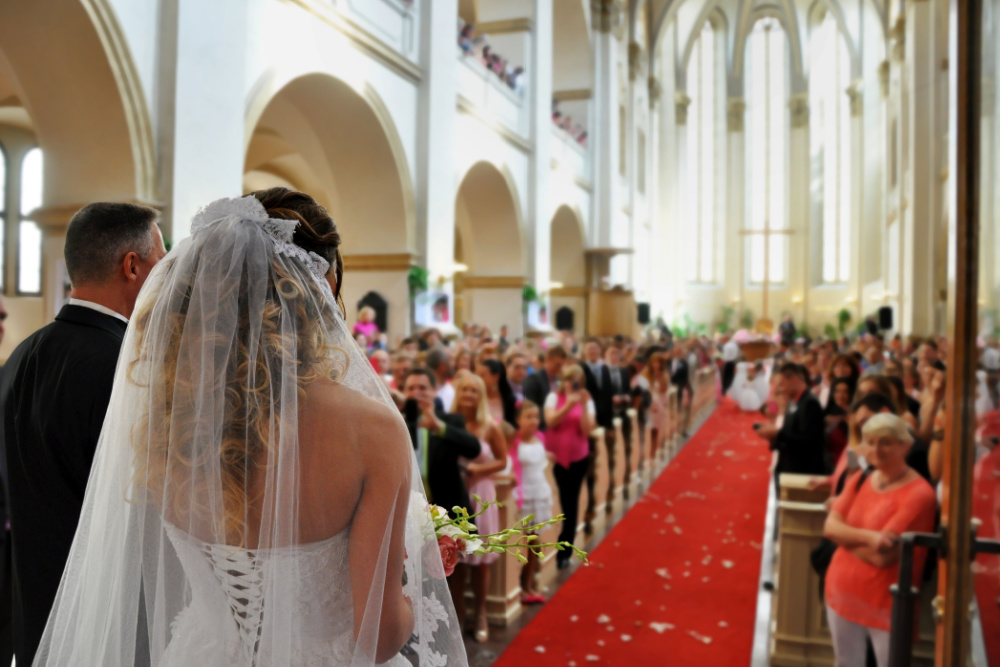 bride walking down the aisle in a church wedding