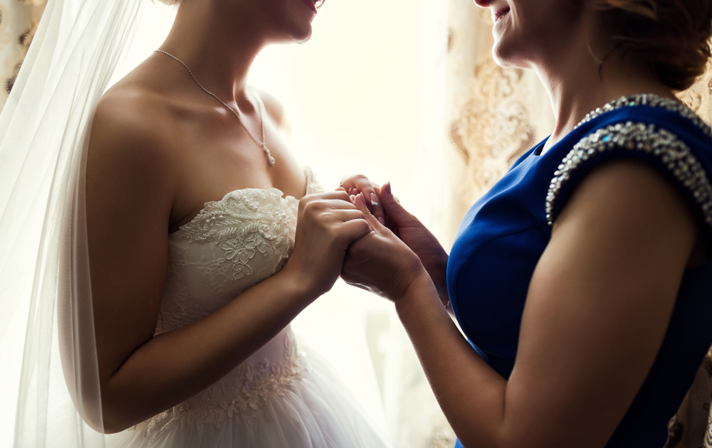 Bride,On,Wedding,Day,Holding,Her,Mother's,Hands.,Concept,Of
