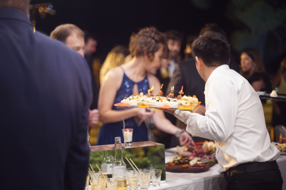 wedding guests eating at the grazing table