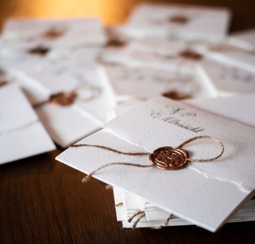 pile of wedding invitations with oil seal