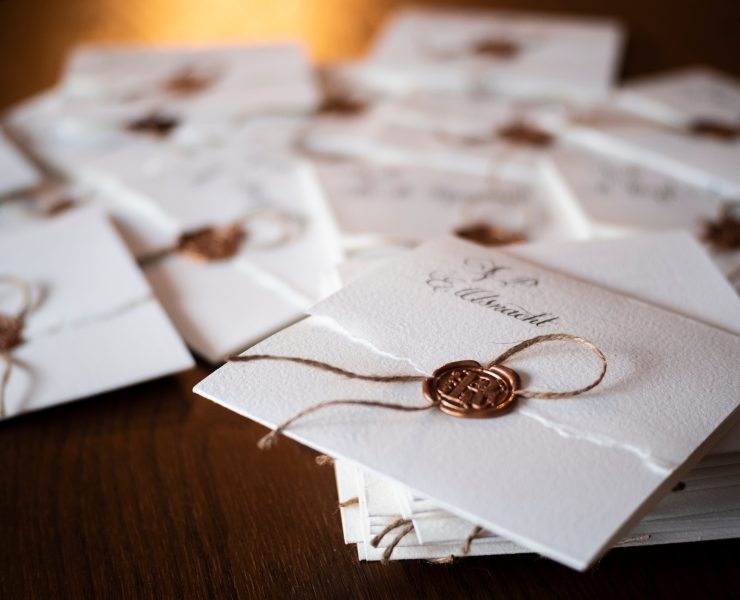 pile of wedding invitations with oil seal