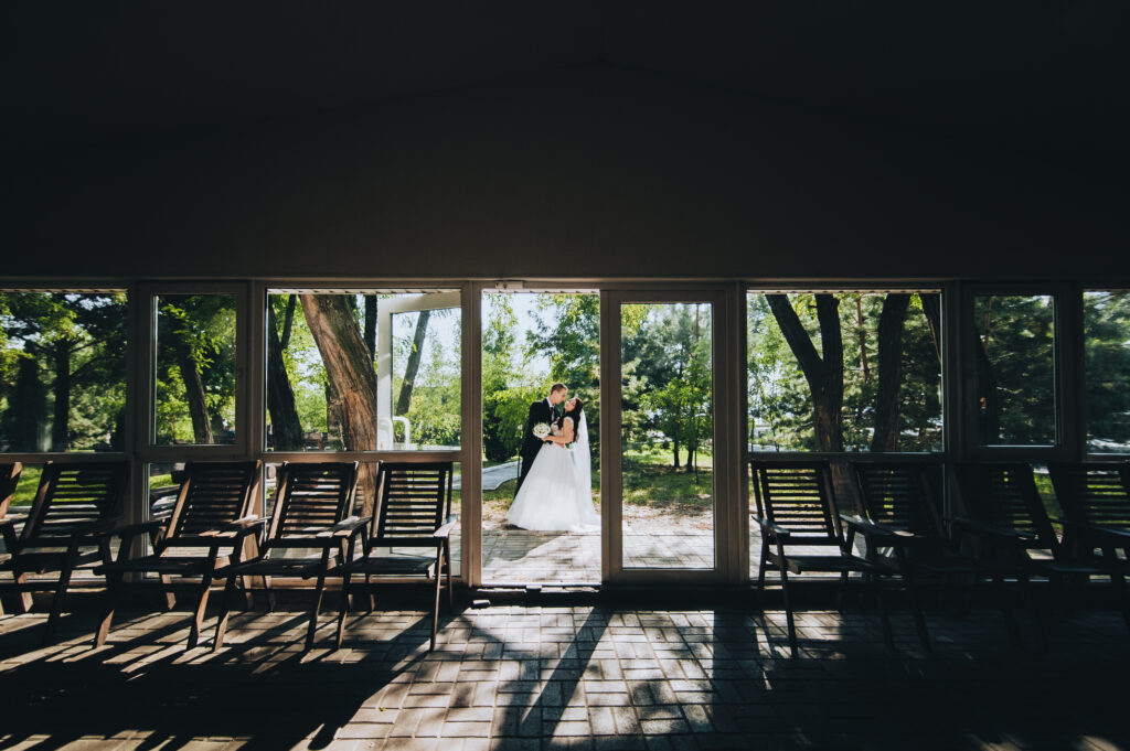 Newlyweds among the trees and sunlight