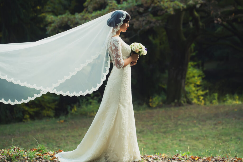 a bride wearing a full lace wedding veil