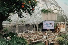 A scenic outdoor wedding venue featuring a stone path leading to a white domed gazebo surrounded by lush gardens.