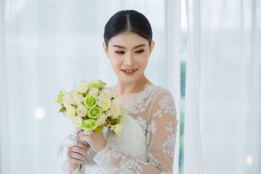 Beautiful bride with wedding flowers bouquet